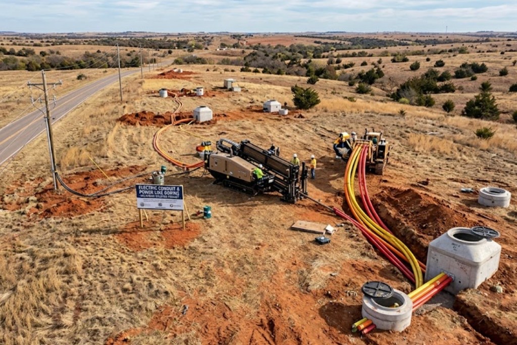 Directional drilling in Muskogee, OK — aerial view of HDD rig, vacuum truck, and safety-marked directional boring field site